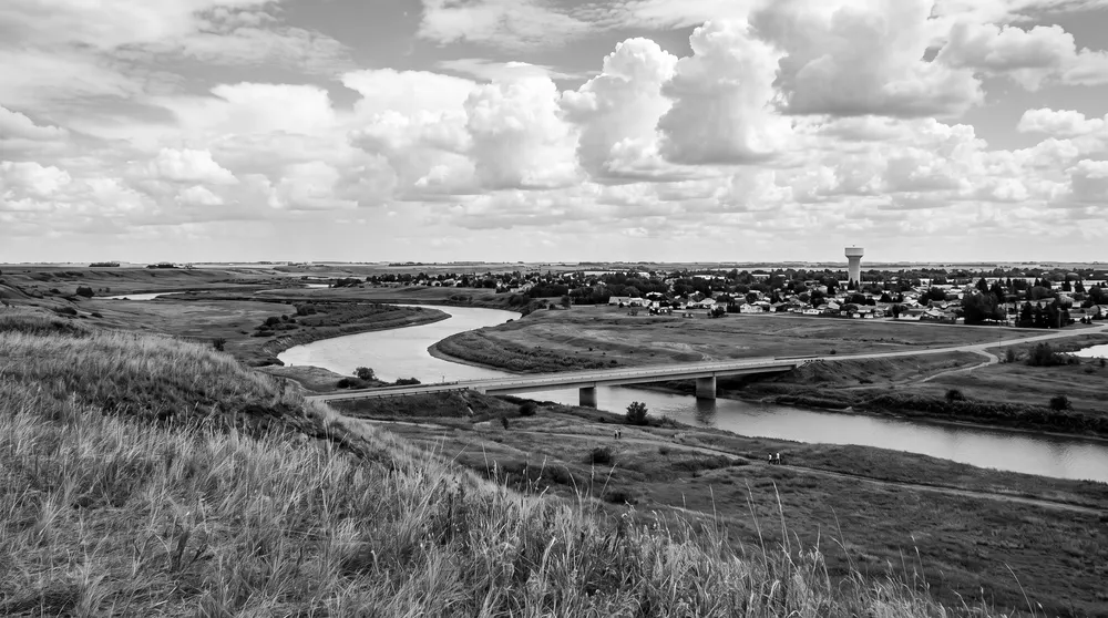 Prairie river valley with a low bridge
